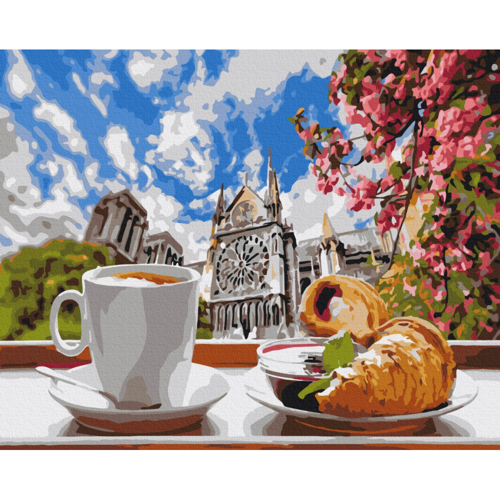 Кава з круасаном на фоні собору